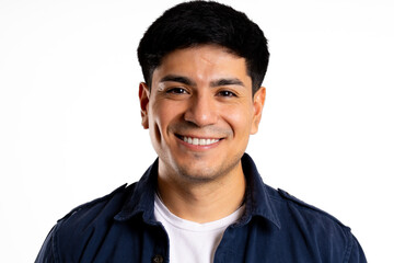 Headshot of smiling young latin man on plain white background