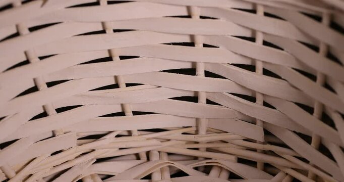 wicker basket for food or other items, natural branches painted white from which a decorative basket is woven, closeup