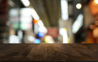 Empty wood table top and blur of restaurant background selective focus product display