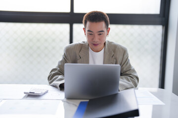 Fototapeta premium Business man working using laptop computer Hands typing keyboard. Professional investor working start up project. business planning in office. Technology business