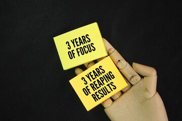 Colored paper with the words 3 years of focus and 3 years of reaping the results. hard work...