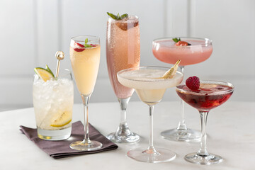 Five elegant cocktails with fresh fruit garnishes