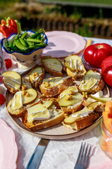 Platter of pear and blue cheese bruschetta on a beautifully decorated table