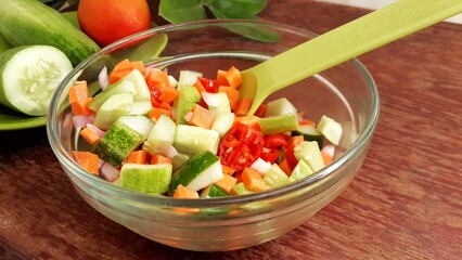 Fresh pickles of various vegetables and fruits are served in glass bowls on the table.
