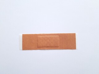 Unbranded wound plaster or band aid isolated on white background.