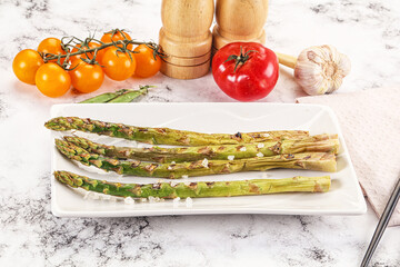 Grilled asparagus sprouts served red pepper