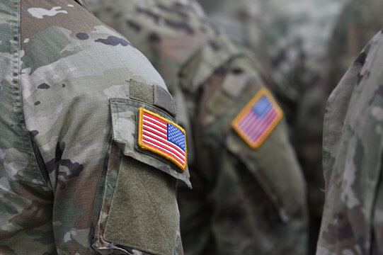 Person wearing military clothes with national symbol.
