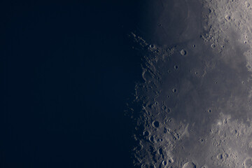 Close-up view of the moon's craters along lunar terminator. Planetary astrophotography Satellite of...