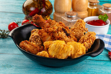 Golden crispy fried chicken mix - wings, drumsticks, nuggets and strips