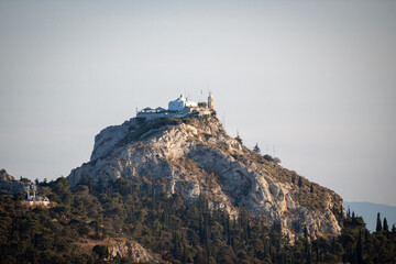 Photo of the Lycabettus hill at Athens city. Clear sky at the background.