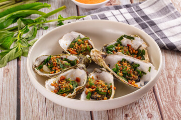 Gournet grilled oysters with onion and peanut