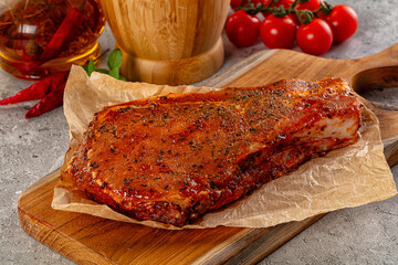 Raw marinated pork loin steak