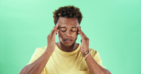 Tired man, headache or stress in studio with green background for injury, burnout or anxiety. Male...