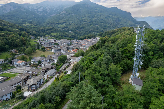 Drone panorama of the Ivrea Morainic Amphitheatre seen from Brosso, Val Chiusella, Italy, showing lush green plains, woods, and scattered villages under clear sky, high drone shot, slow motion