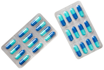 Blue capsules in the plastic blister, isolated on white background, top view.