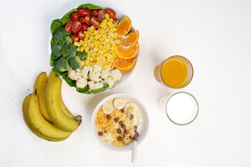 Colorful top-view bowl of fresh fruit, oats, and seeds showcasing a healthy, organic, vegan breakfast rich in vitamins and fiber.