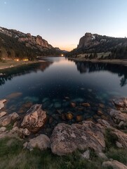 Serene lake at dawn, reflecting mountains