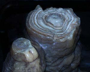 Beautifully layered stone formation showcasing natural patterns, likely found in a cave or...