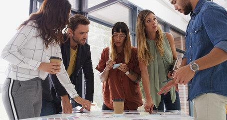 Team, creative business people and planning in meeting with brand strategist writing notes. Group, manager or collaboration in startup office for discussion, brainstorming idea or ad campaign design