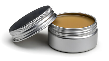 An open silver tin jar filled with golden ointment sits on a white surface with its lid resting nearby casting a soft shadow showing skincare or healthcare.