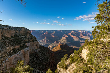 Panoramic views of the Grand Canyon, Arizona, USA, showcasing the dramatic landscape, layered rock formations, and vivid colors under a clear sky. Perfect for travel and nature themes.