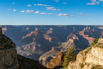 Panoramic views of the Grand Canyon, Arizona, USA, showcasing the dramatic landscape, layered rock formations, and vivid colors under a clear sky. Perfect for travel and nature themes.