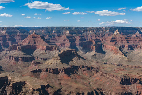 Panoramic views of the Grand Canyon, Arizona, USA, showcasing the dramatic landscape, layered rock formations, and vivid colors under a clear sky. Perfect for travel and nature themes. - Powered by Adobe