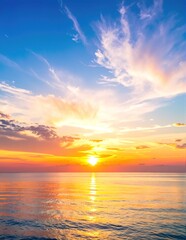 Obraz premium A breathtaking sunset casts vibrant hues of orange, pink, and purple across the sky, reflecting on the calm ocean waves, creating a serene atmosphere.