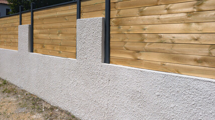 wall cinder block wall and wooden fence with structure street wood barrier private house protect...