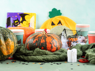 Halloween party setting with pumpkins, candies and decor