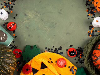 Halloween green frame background flatlay with pumpkins and party decor