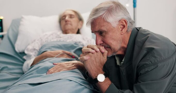 Crying, sad and elderly couple in hospital bed with bad news, terminal diagnosis or medical results. Healthcare, marriage and man with woman praying for healing, support and hope for surgery recovery