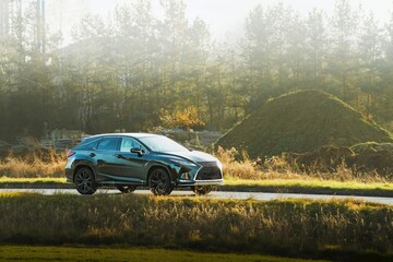 SUV on a country road in sunlight