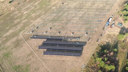 Solar panel assembly in progress on open land
