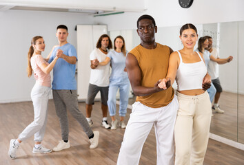 Fototapeta premium Adult male and young female dancing pair dance in dance hall