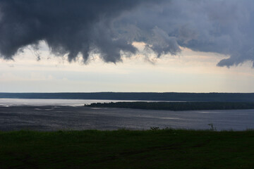 Dramatic Sky and Dark Clouds Over a Calm Lake
