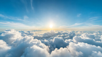 Fototapeta premium A stunning view of a bright sun rising above fluffy clouds in a clear blue sky, evoking a sense of peace and tranquility.