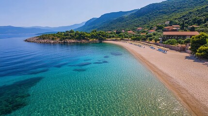 Sunny beach with golden sand and crystal clear water.