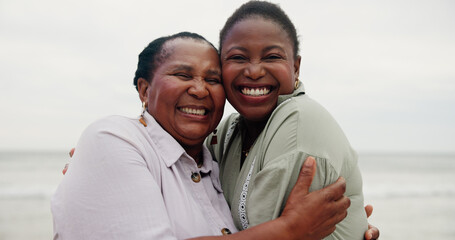 Portrait, mother and daughter with hug by ocean for travel, sea holiday and getaway. Women, African family and embrace with mature mom for affection, beach vacation and bonding together for trip
