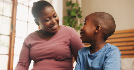 Obraz premium Home, black family and mother with boy, conversation and bonding together in bedroom. African parent, mama and son with discussion, smile and happiness with love, chatting and break with child