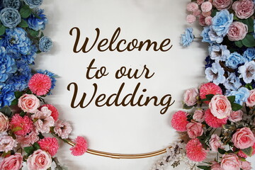 Welcome to our Wedding text with flowers decorations on wooden background