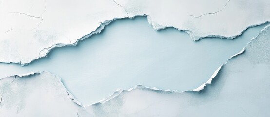 Obraz premium Cracked wall surface with a light blue background creating a textured and artistic feel
