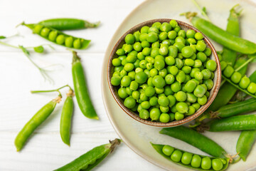 Fresh green pea pods with green peas on a wooden background. Sweet green peas. Green pea beans vegetables. Vegan. healthy vegetable. Copy space