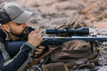 Hunter preparing bolt action rifle for hunting