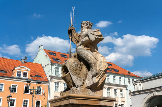 Fountain, sculpture made of sandstone by Johannes Nitsche dates back to 1794. Neptune with trident in his right hand, sitting on dolphin. Market Square (Rynek). Gliwice, Poland.