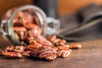 Peeled pecan nuts on wooden table.
