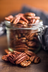 Peeled pecan nuts on wooden table.