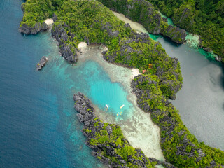 Kayaks over clear turquoise water in Small Lagoon in Miniloc Island. El Nido, Palawan. Philippines.