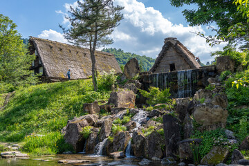 Traditional houses and waterfall pond in Shirakawa-go, Japan