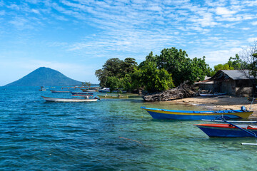 Small port on Bunaken Island Sulawesi Indonesia with volcano view